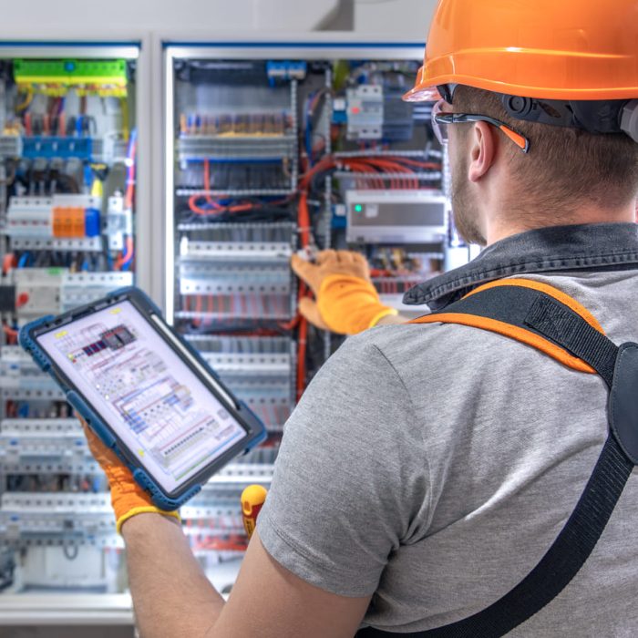 a-male-electrician-in-overalls-focused-on-work-in-2025-03-15-19-39-15-utc